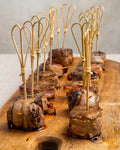 Pinchos de filete con tocino y reducción de vino para eventos gourmet en Santiago.